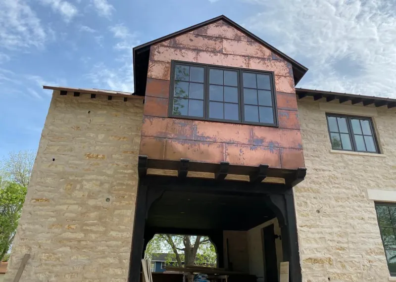 Copper metal panel facade on a stone building for Roof Repair in Port Arthur