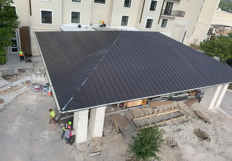 Metal roofing installation team working on a commercial building in Port Arthur