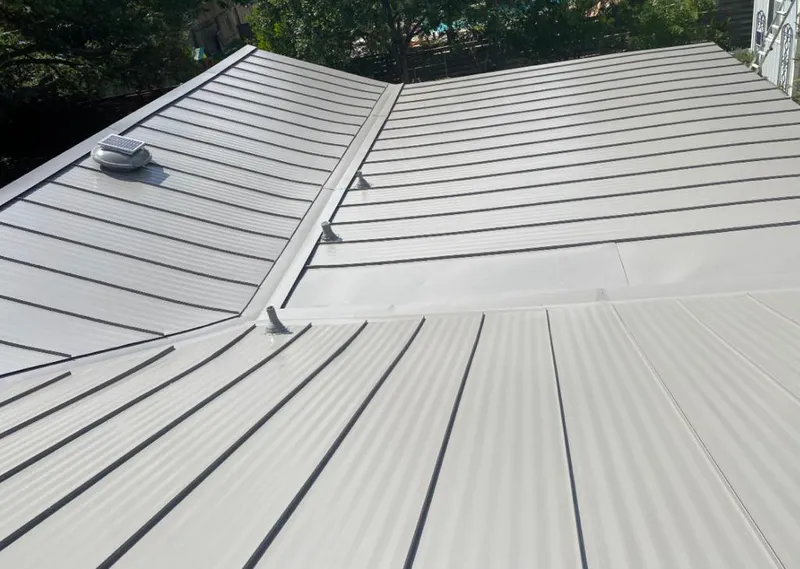Solar attic fan installed on a metal roof for Roof Ventilation in Port Arthur